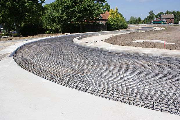 Oval roundabout - in Nieuw Bergen made of continuously reinforced concrete. The province of Limburg opted for concrete because this material is resistant to the high torsional forces of truck traffic and shows no rutting. For the separate cycle paths concrete has been chosen due to the absence of root heave. The province assumes a lifespan of forty years without much maintenance. Photo: Betonhuis.  
